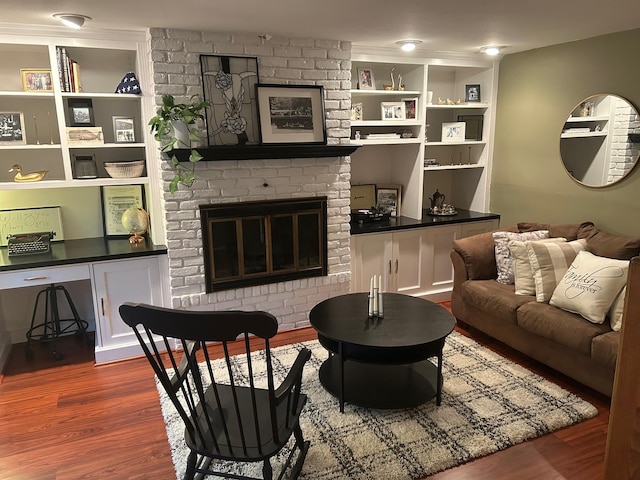 118 Skyline Dr, Coram, NY 11727 - living room featuring wood finished floors, built in shelves, and a fireplace