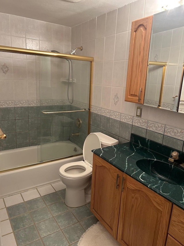 118 Skyline Dr, Coram, NY 11727 - bathroom featuring tile walls, vanity, toilet, combined bath / shower with glass door, and tile patterned flooring