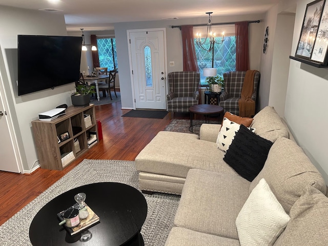 118 Skyline Dr, Coram, NY 11727 - living area with wood finished floors, a chandelier, and baseboards