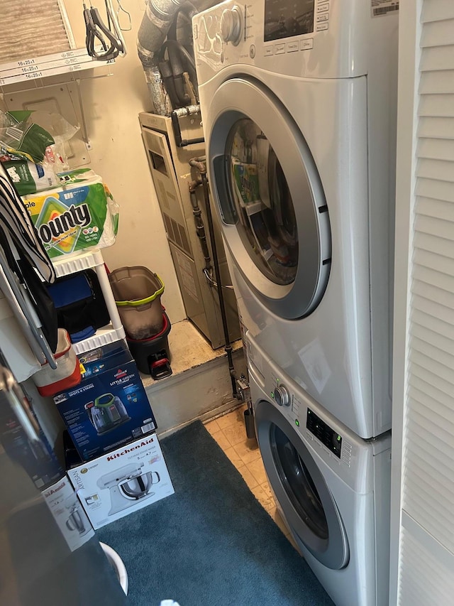 118 Skyline Dr, Coram, NY 11727 - laundry area with stacked washer / dryer and tile patterned flooring