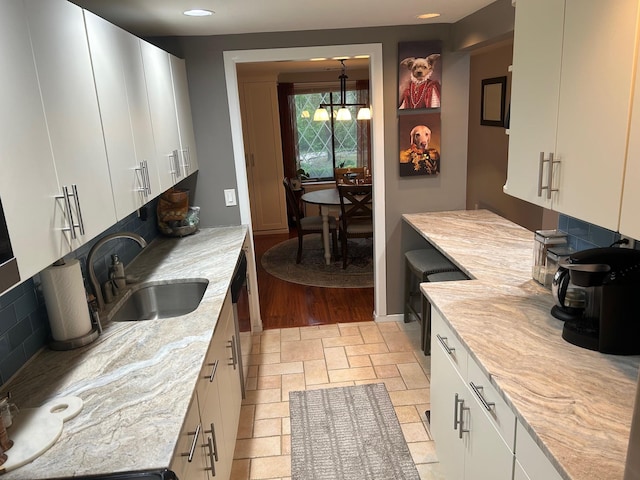 118 Skyline Dr, Coram, NY 11727 - kitchen with a sink, white cabinets, light stone countertops, light stone finish flooring, and decorative backsplash