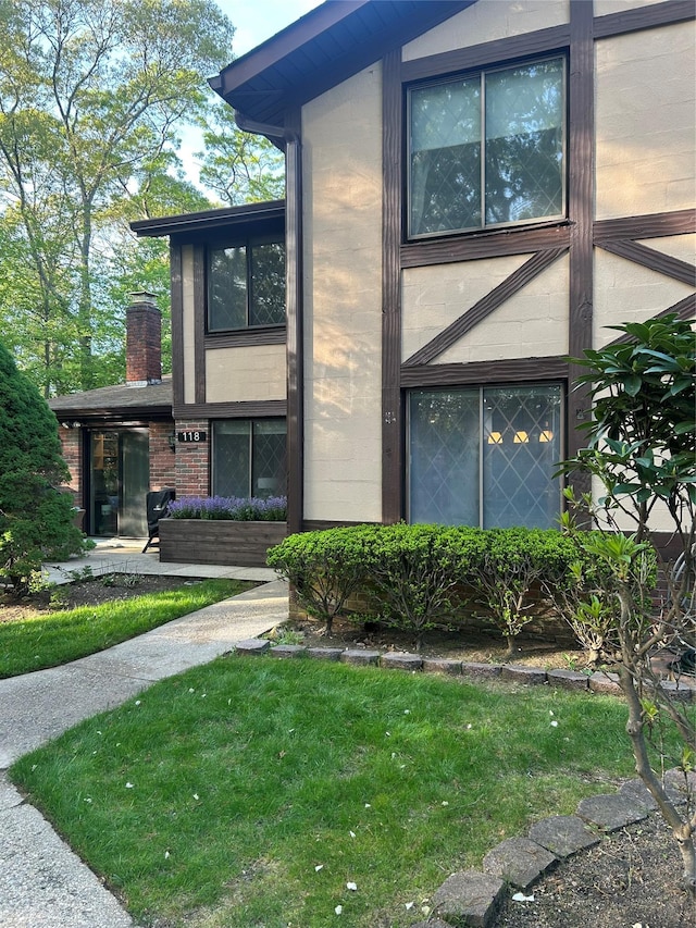 118 Skyline Dr, Coram, NY 11727 - view of front of home with a front lawn, brick siding, and a chimney