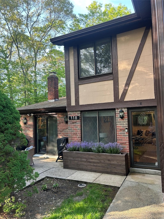 118 Skyline Dr, Coram, NY 11727 - back of house with brick siding and a chimney
