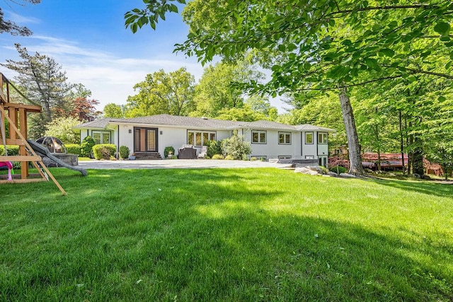 8 Beaumont Dr, New City, NY 10956 - rear view of house featuring a yard and stucco siding