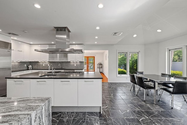 8 Beaumont Dr, New City, NY 10956 - kitchen with modern cabinets, island range hood, dark countertops, a sink, and white cabinets