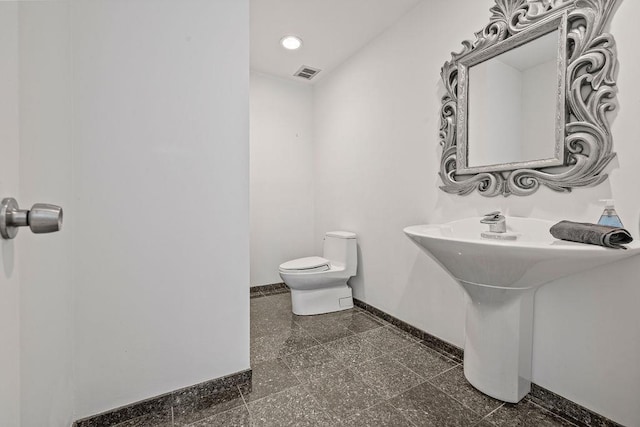 8 Beaumont Dr, New City, NY 10956 - half bathroom featuring baseboards, toilet, granite floors, recessed lighting, and a sink