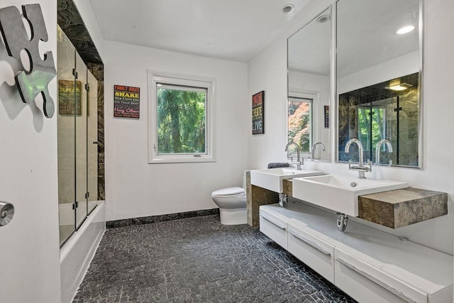 8 Beaumont Dr, New City, NY 10956 - full bathroom featuring toilet, combined bath / shower with glass door, baseboards, and double vanity