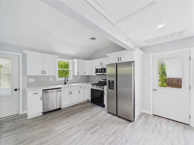 495 Easton St, Ronkonkoma, NY 11779 - kitchen with stainless steel appliances, a sink, decorative backsplash, light countertops, and white cabinets