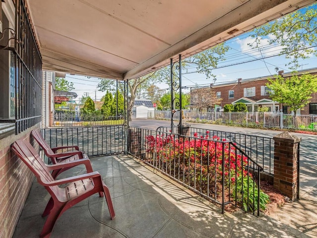 view of patio / terrace with a porch and fence