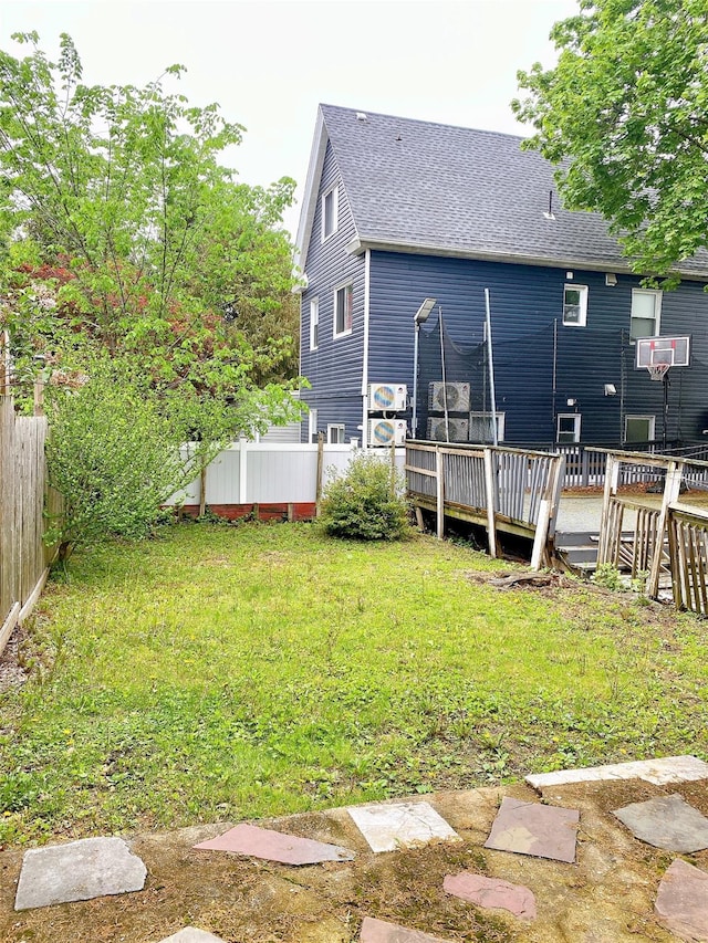 view of yard featuring cooling unit, a deck, and a fenced backyard