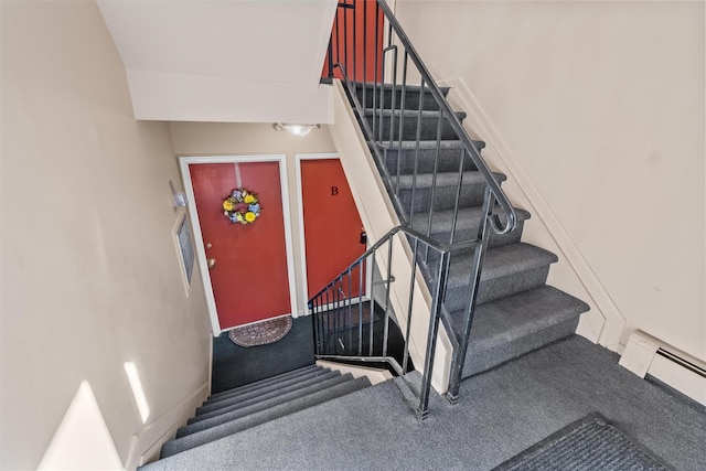 stairs with a baseboard radiator