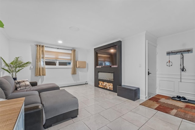 living area featuring a baseboard heating unit, a glass covered fireplace, crown molding, and light tile patterned floors