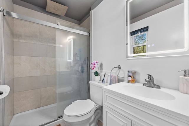 full bathroom with toilet, a shower stall, and vanity