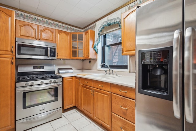 139-15 83rd Ave Unit 409, Briarwood, NY 11435 - kitchen with stainless steel appliances, a sink, light countertops, brown cabinets, and light tile patterned floors