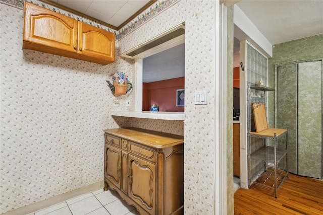 139-15 83rd Ave Unit 409, Briarwood, NY 11435 - bathroom with wallpapered walls and wood finished floors