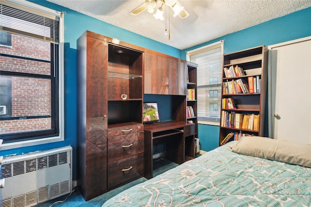139-15 83rd Ave Unit 409, Briarwood, NY 11435 - bedroom with radiator heating unit, a textured ceiling, and a ceiling fan