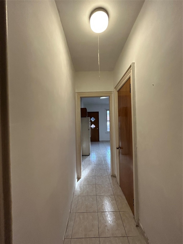 hallway featuring light tile patterned floors