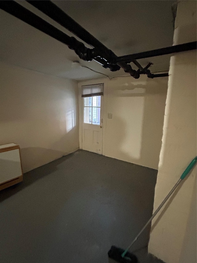 unfurnished room featuring concrete flooring