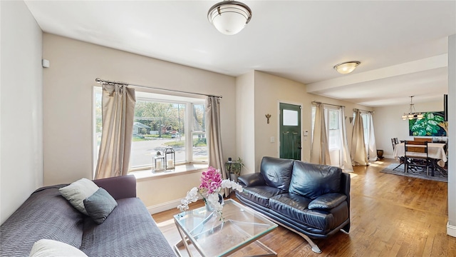 1079 Candlewood Rd, Brentwood, NY 11717 - living area with light wood-style floors, a chandelier, and baseboards