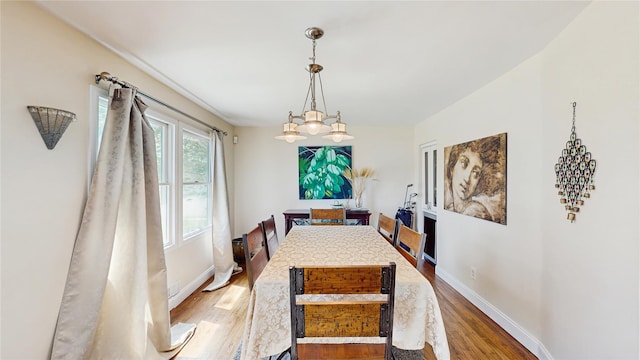 1079 Candlewood Rd, Brentwood, NY 11717 - dining space featuring wood finished floors, baseboards, and a chandelier