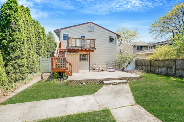 back of property featuring a deck and a gate