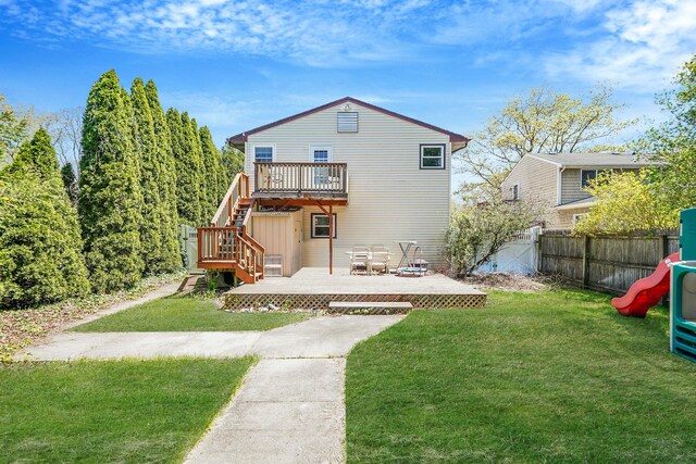 back of property featuring a deck and stairway