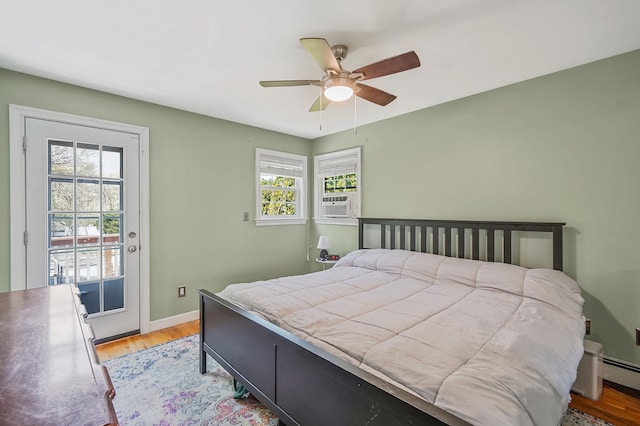bedroom featuring multiple windows, access to exterior, light wood-style floors, and ceiling fan