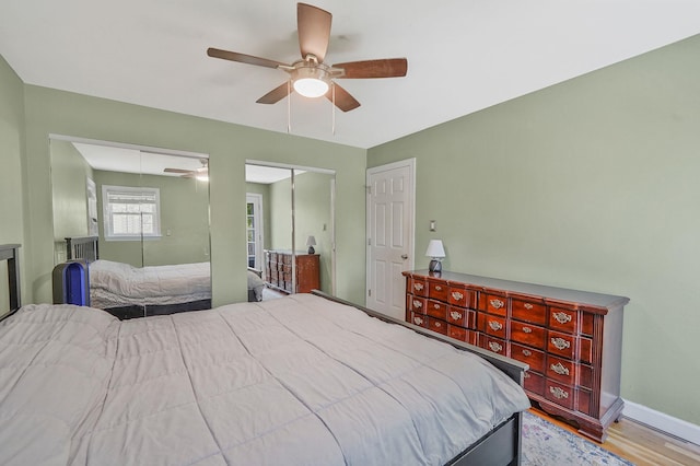 bedroom with wood finished floors, a ceiling fan, and baseboards