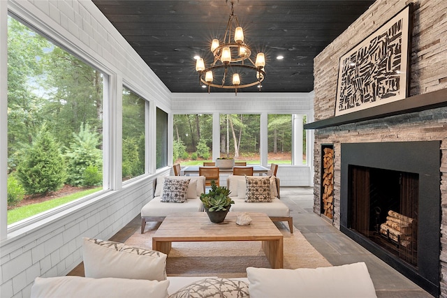 sunroom / solarium with wooden ceiling and a chandelier