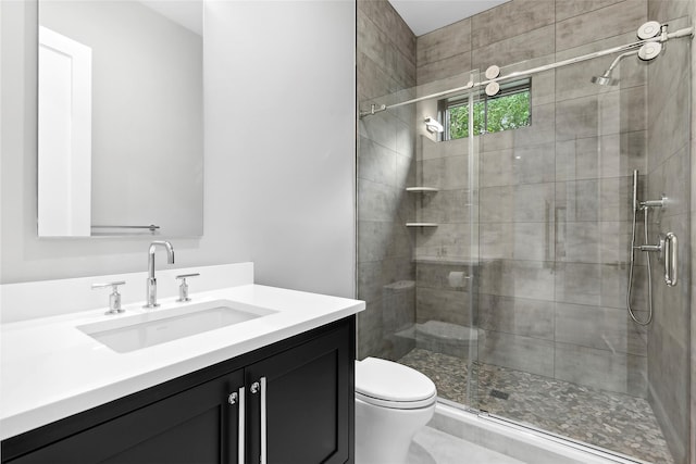 full bathroom with a stall shower, toilet, and vanity