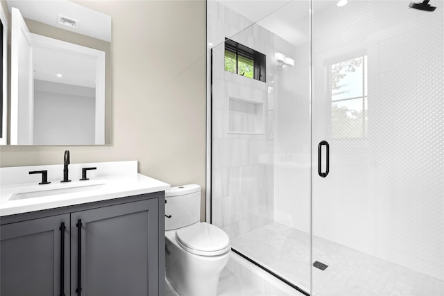 full bathroom with toilet, a shower stall, vanity, and marble finish floors