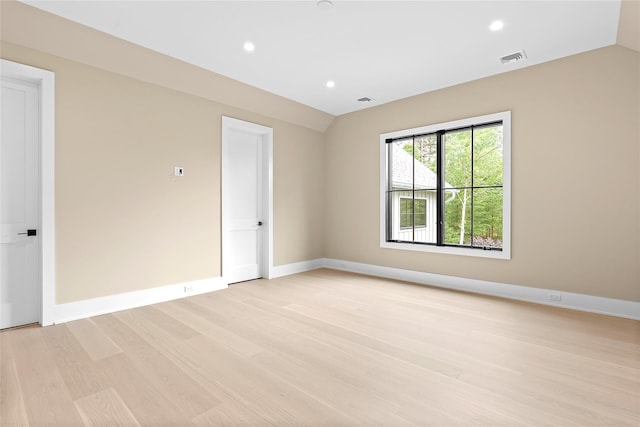 unfurnished room with light wood-style flooring, vaulted ceiling, recessed lighting, and baseboards