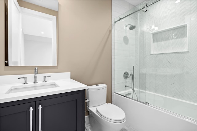 bathroom featuring vanity, toilet, and shower / bath combination with glass door