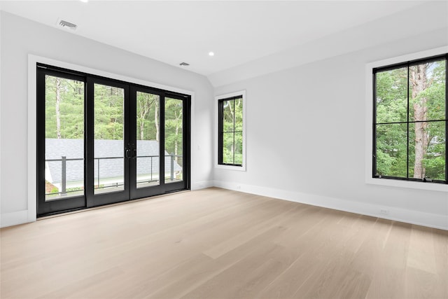 unfurnished room with french doors, light wood-type flooring, baseboards, and recessed lighting