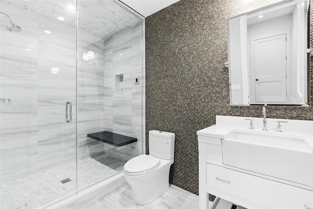 full bathroom featuring tile walls, toilet, a shower stall, and vanity