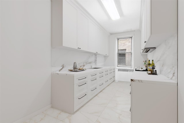 43-08 41st St Unit 5D, Sunnyside, NY 11357 - bar area featuring light marble finish floors, a sink, and radiator