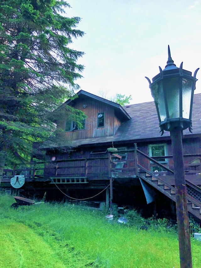 view of side of property featuring stairway