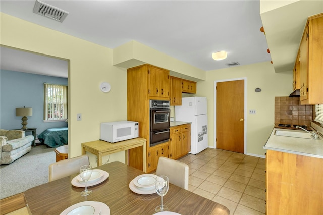 12 Harvard Dr, Hampton Bays, NY 11946 - kitchen featuring white appliances, a sink, light countertops, a warming drawer, and decorative backsplash