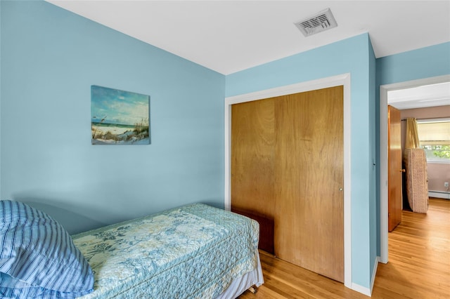 12 Harvard Dr, Hampton Bays, NY 11946 - bedroom with wood finished floors, a closet, and baseboards