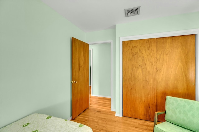 12 Harvard Dr, Hampton Bays, NY 11946 - bedroom with light wood finished floors, a closet, and baseboards