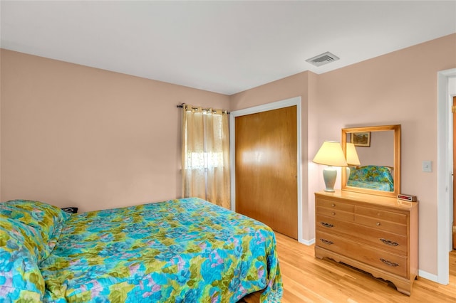 12 Harvard Dr, Hampton Bays, NY 11946 - bedroom with light wood-type flooring, a closet, and baseboards