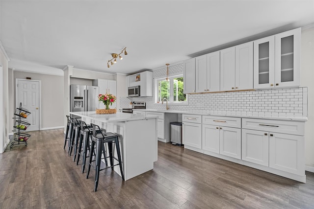 8 Red Oak Ct, Middletown, NY 10941 - kitchen featuring stainless steel appliances, a breakfast bar, decorative backsplash, and dark wood finished floors