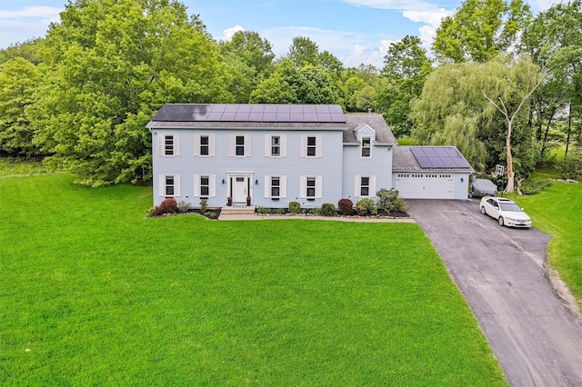 8 Red Oak Ct, Middletown, NY 10941 - colonial inspired home featuring roof mounted solar panels, a garage, a front lawn, and asphalt driveway