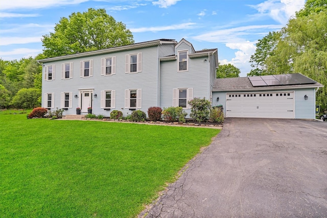 8 Red Oak Ct, Middletown, NY 10941 - colonial house featuring solar panels, a front lawn, driveway, and an attached garage