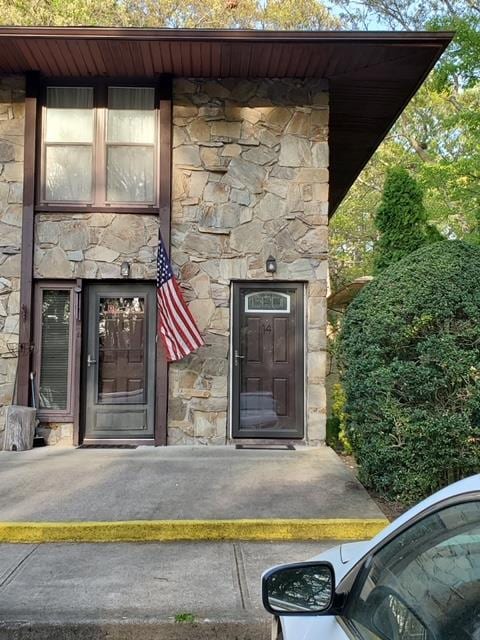 view of exterior entry featuring stone siding