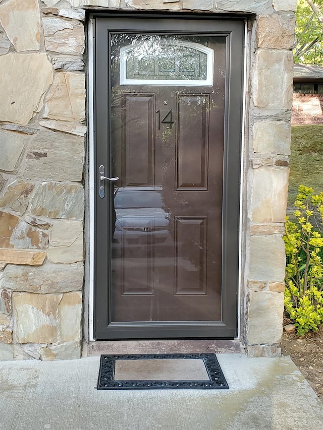 property entrance featuring stone siding