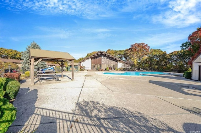 swimming pool with a gazebo and a patio