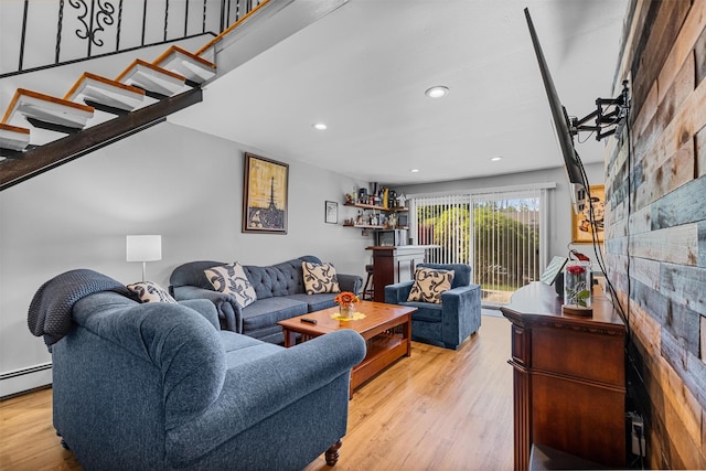 living room featuring wood finished floors, stairs, recessed lighting, and baseboard heating