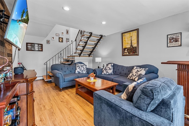 living room featuring stairway, light wood-style flooring, and recessed lighting