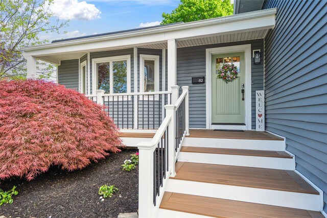 view of exterior entry with a porch